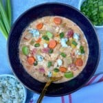 Creamy Buffalo Chicken Chili topped with blue cheese and scallions.