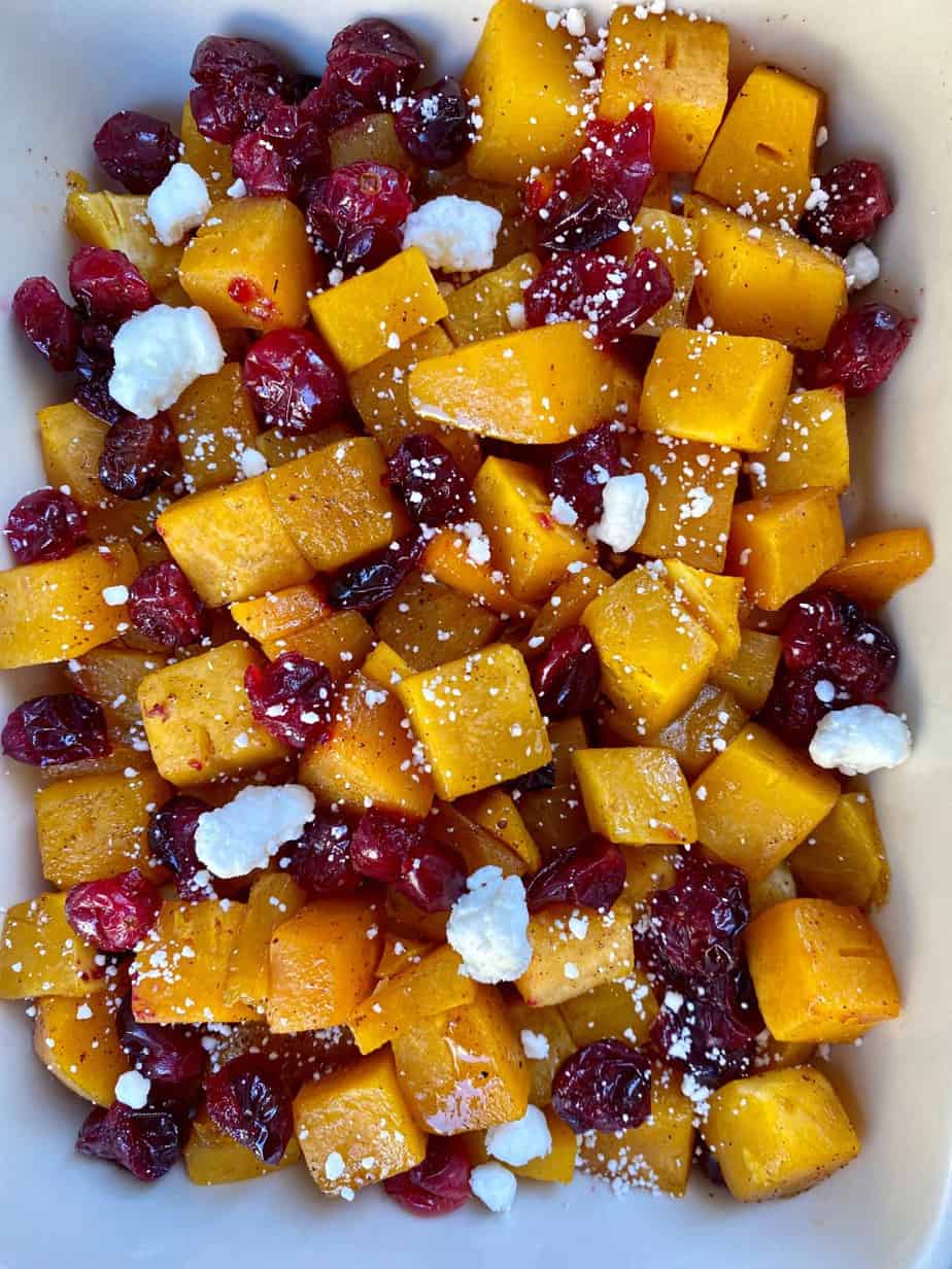 Maple Roasted Butternut Squash and Cranberries with cranberries in a serving dish. Thanksgiving side dish.