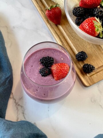 Strawberry Blackberry Banana Smoothie without Yogurt with fresh berries on top.