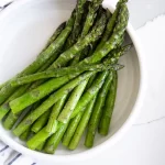 A bowl of air fryer asparagus.