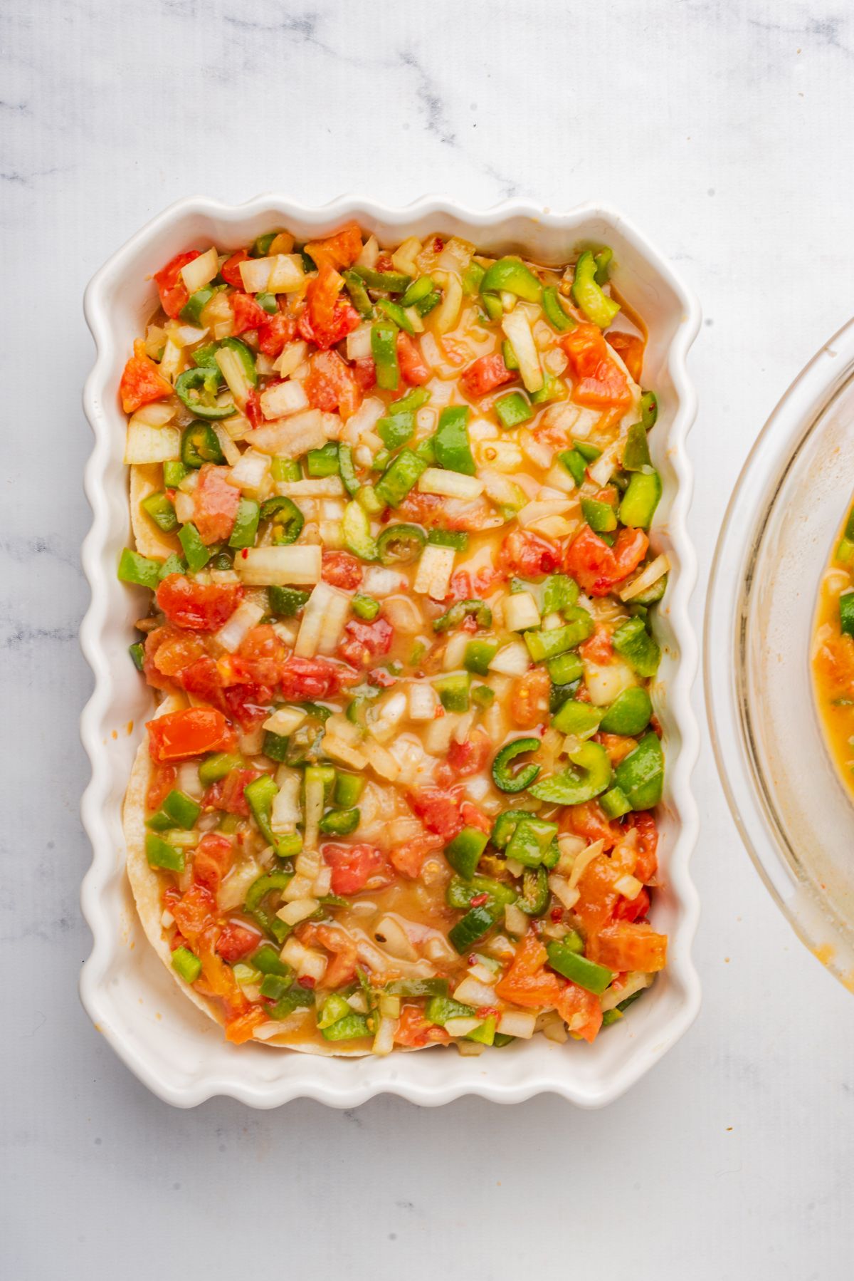 Chopped vegetables and canned soup mixture in a baking dish.