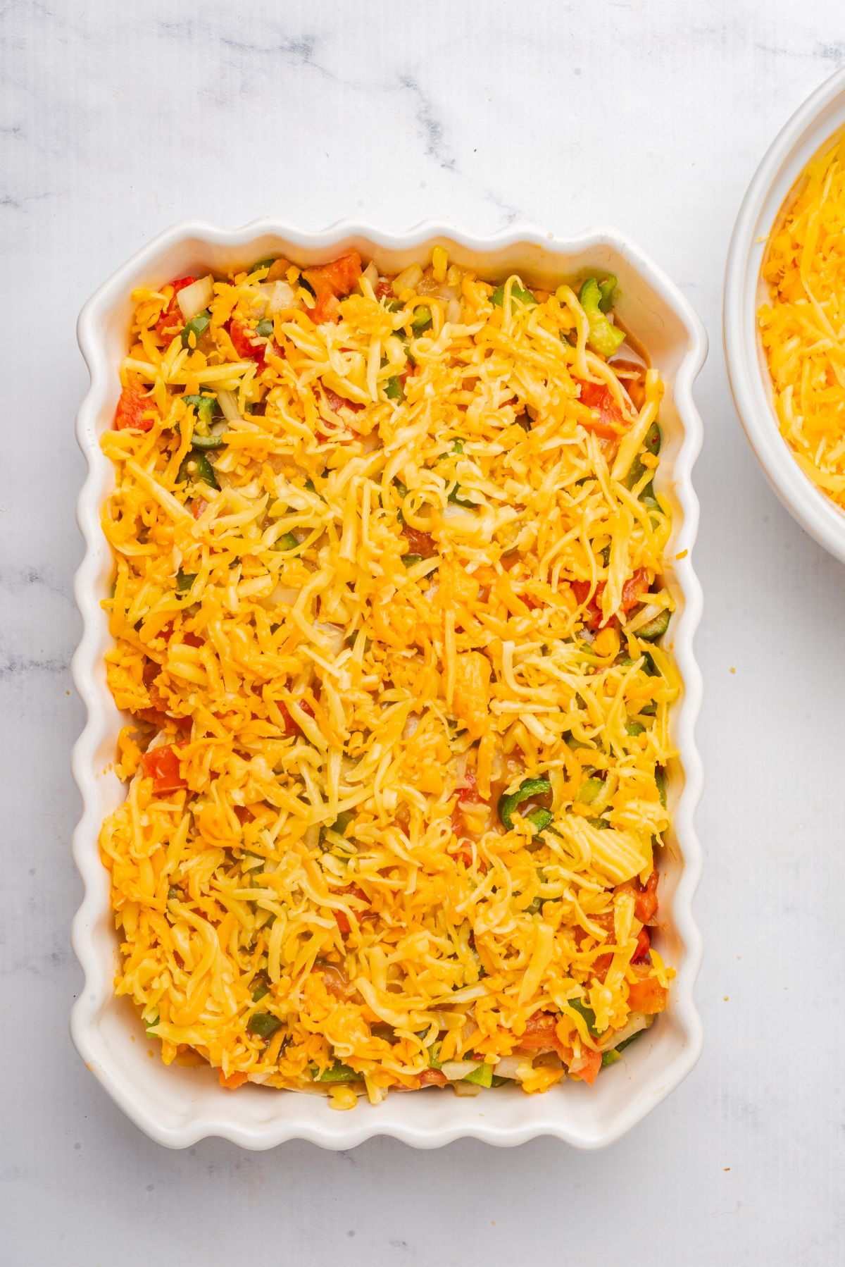 A layer of cheese on top of chicken king ranch casserole.