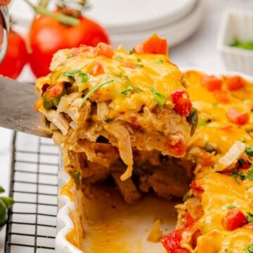 A serving of king ranch chicken casserole on a spatula being removed from the casserole dish.