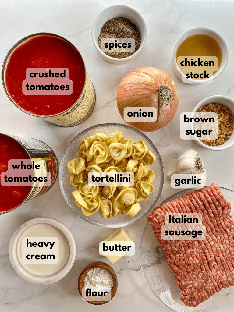 All ingredients needed to make this soup are labeled and on a marble table.