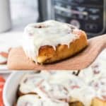 Cinnamon rolls with icing are on a spatula.