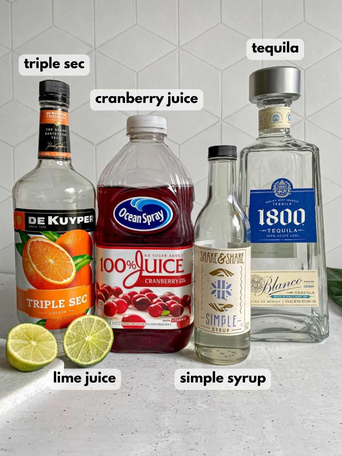 Ingredients needed to make a cranberry margarita: tequila, cranberry juice, triple sec, limes, and simple syrup.