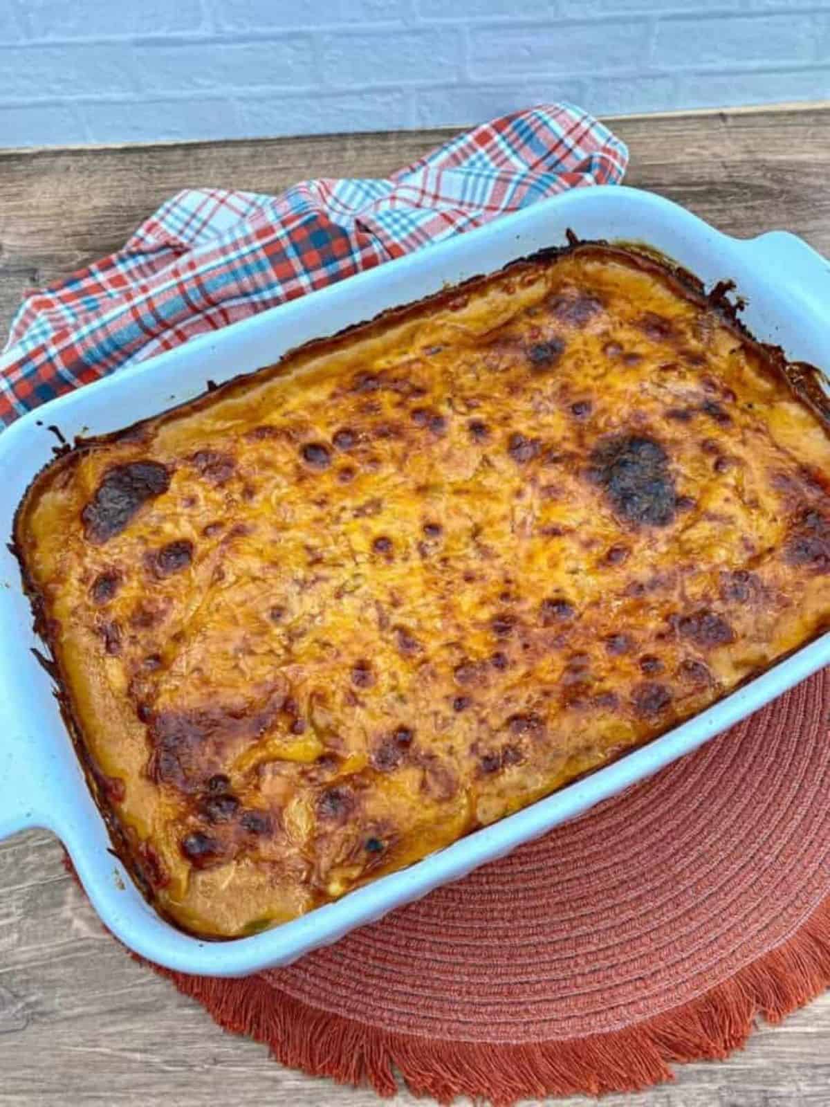 Fully cooked King Ranch Chicken Casserole in a large baking dish with bubbling cheese on the top.