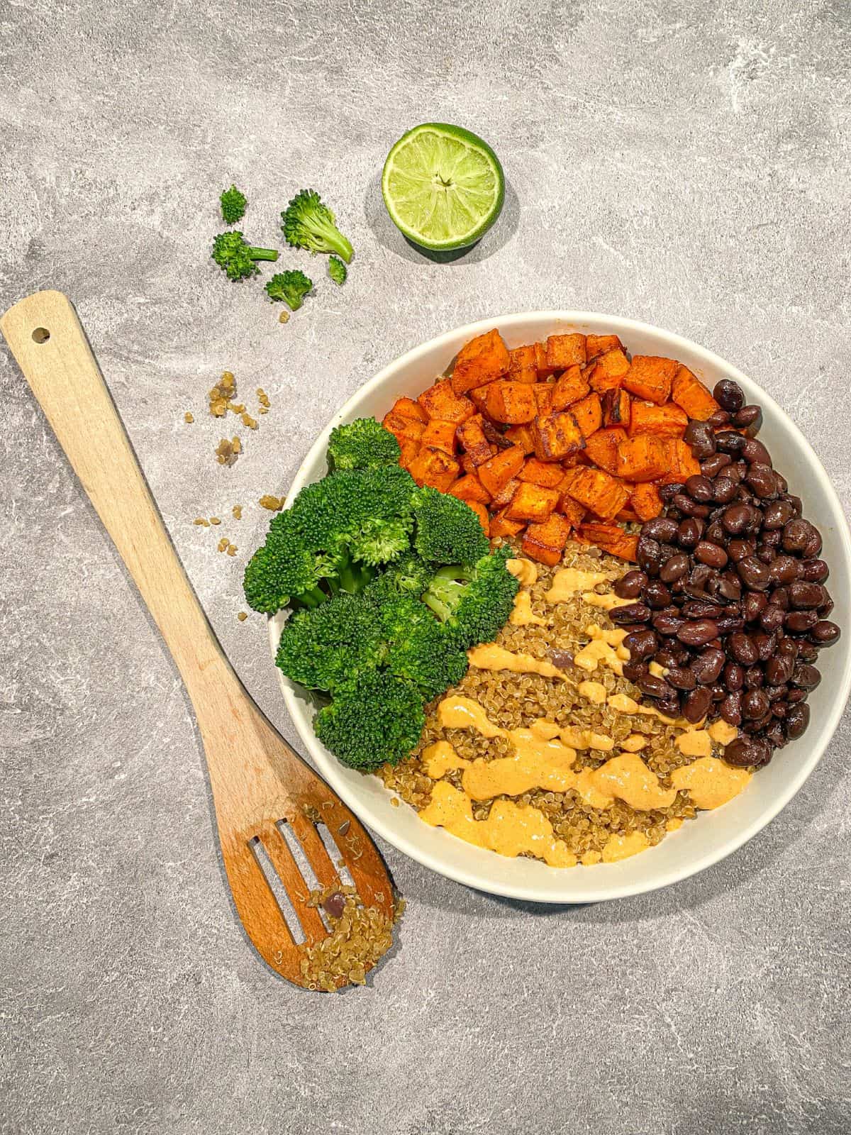 Vegan Taco Bowl with Cashew Sauce topped with black beans, sweet potatoes, and broccoli.
