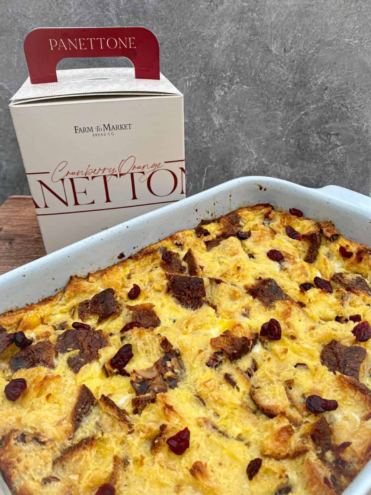 Bread Pudding in a large baking dish next to a box of panettone bread.