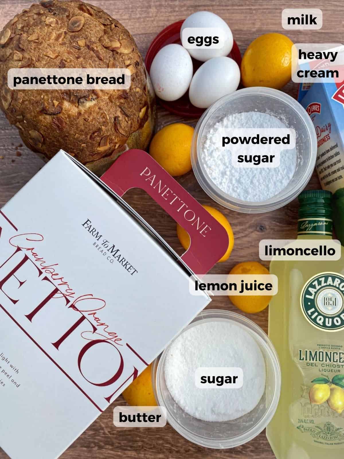 Ingredients needed to make Panettone Bread Pudding with Limoncello Glaze are on a wooden table.