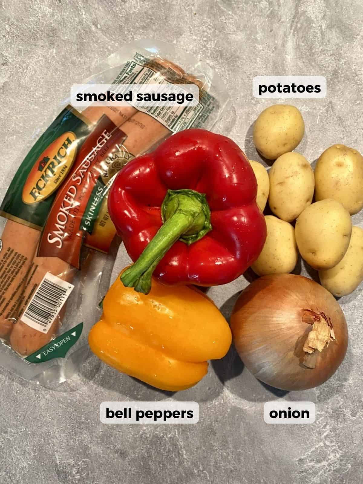 Ingredients needed to make this recipe: smoked sausage, potatoes, peppers, and onions.