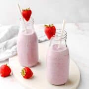 Two glass bottles of Cottage Cheese Smoothies.