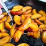 Peaches cooking in a skillet.