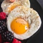 A sunny side up egg and fresh berries.