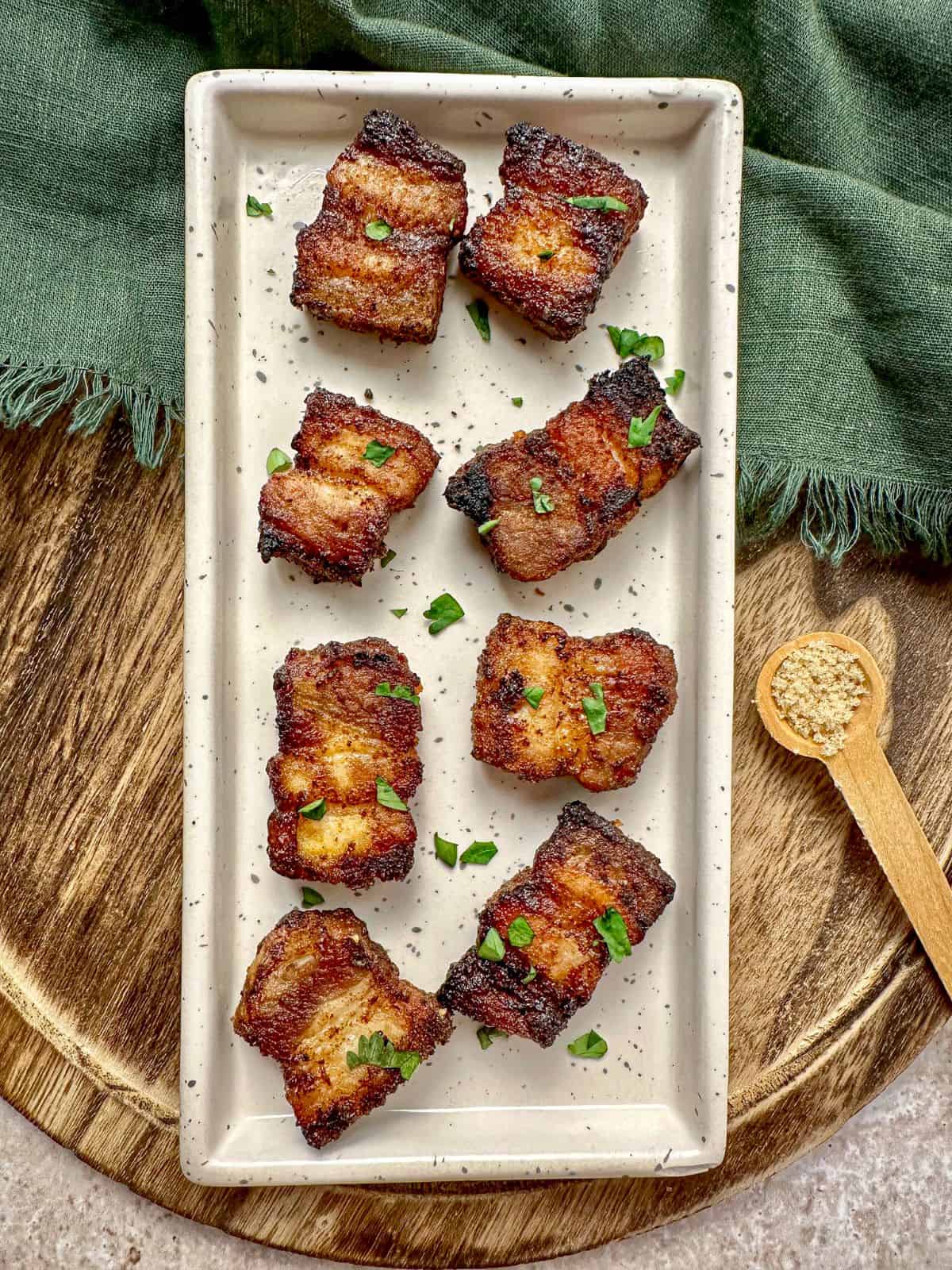 Air fryer pork belly bites on a serving platter.