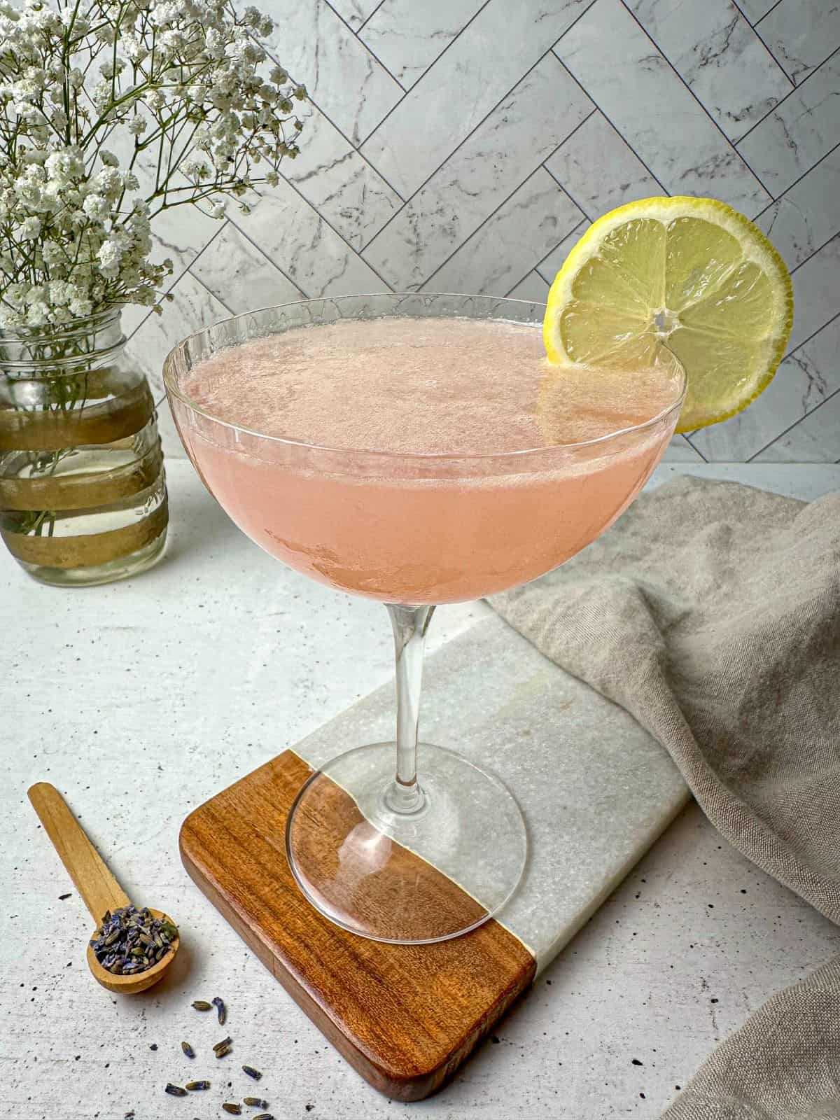 Lavender lemon cocktail with vodka in a martini glass.