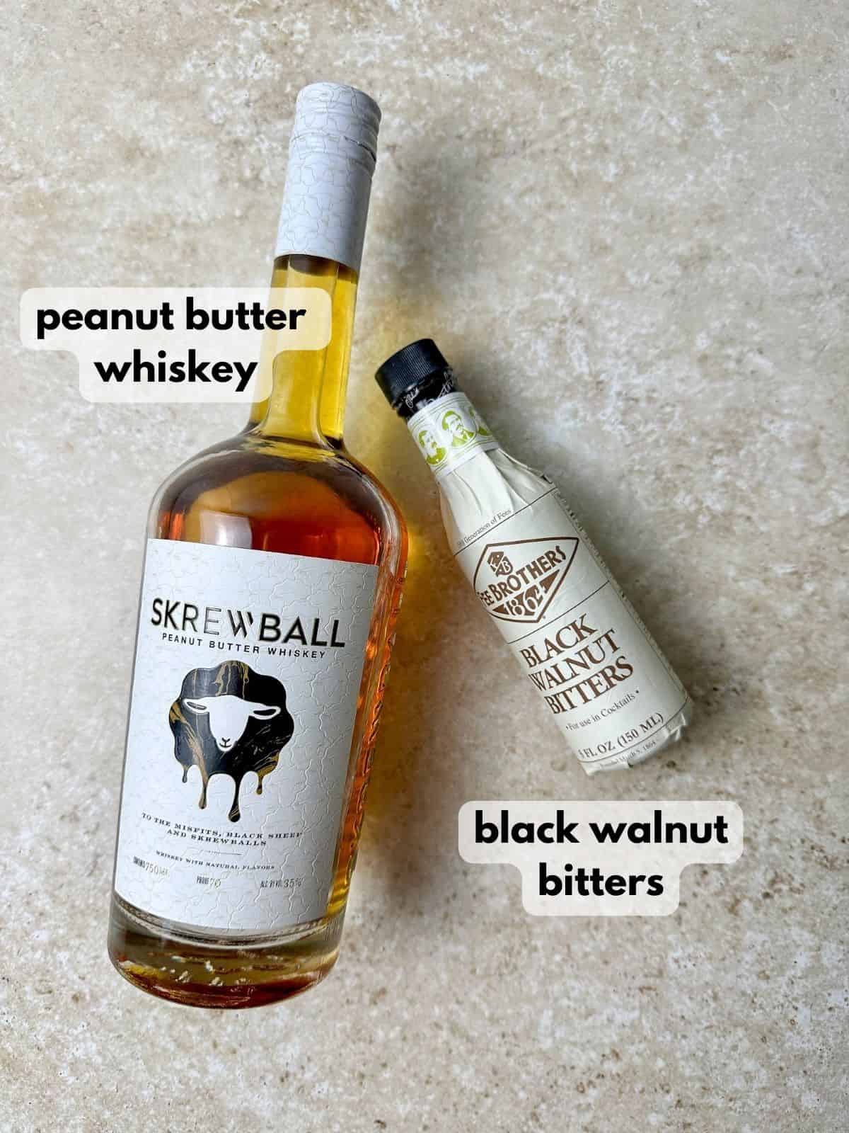 Peanut butter old fashioned ingredients include a bottle of Skrewball whiskey and black walnut bitters.