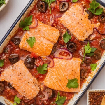 Salmon puttanesca in a baking dish.