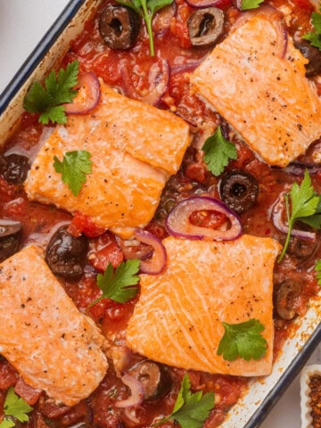 Salmon puttanesca in a baking dish.