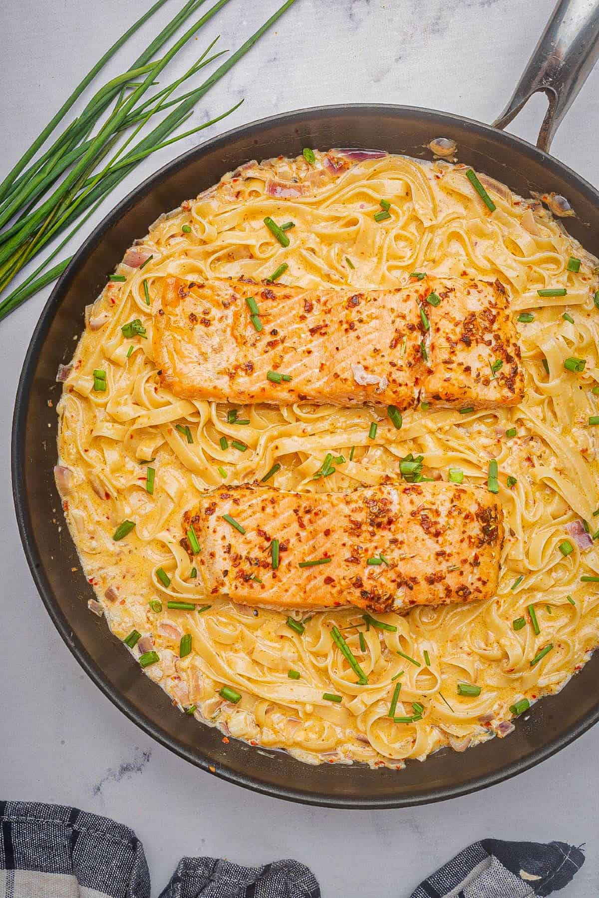 Cajun Alfredo recipe served with salmon and fettucine pasta.