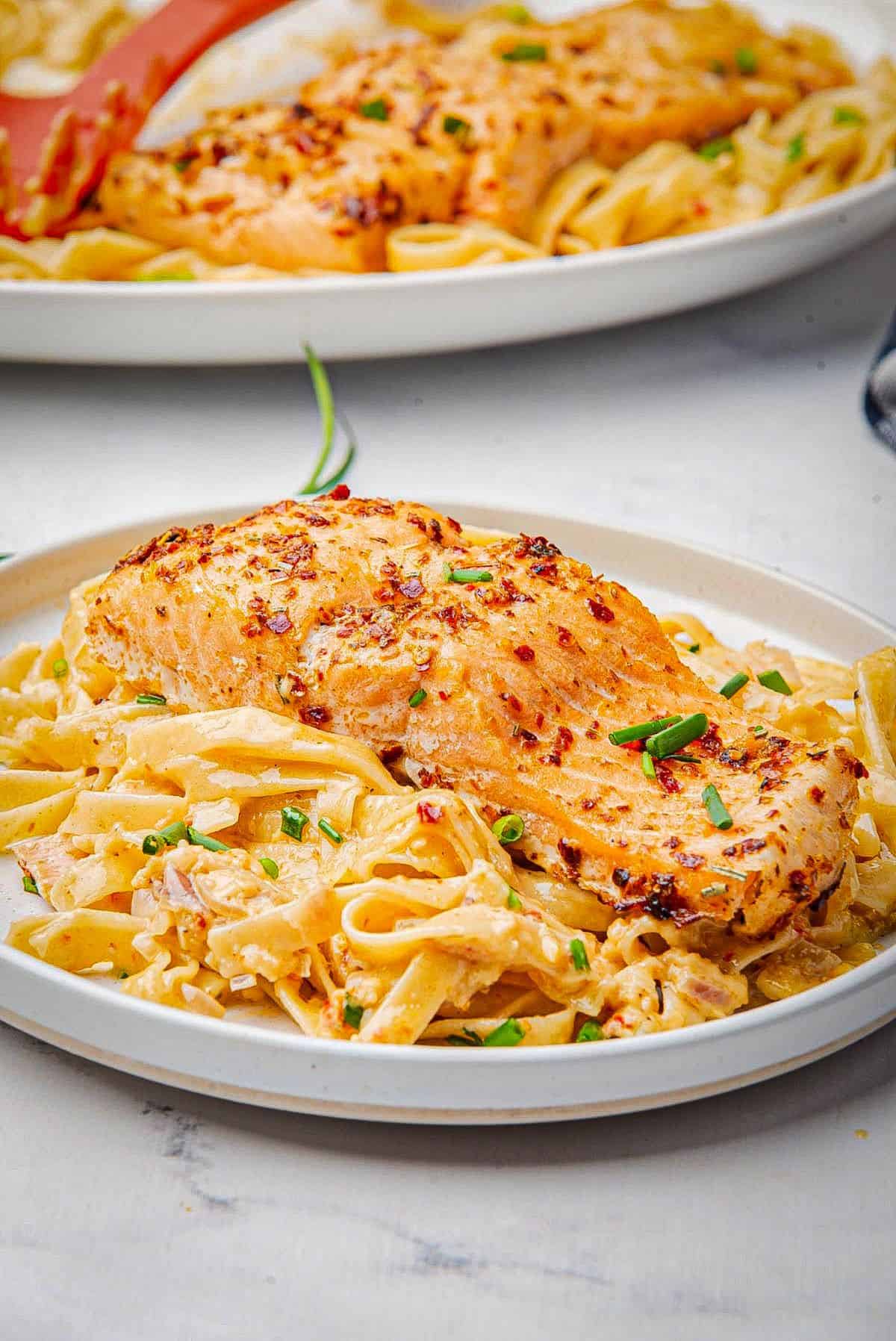 Cajun pasta with salmon on a plate.