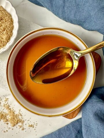 Brown sugar simple syrup in a bowl with a spoon.