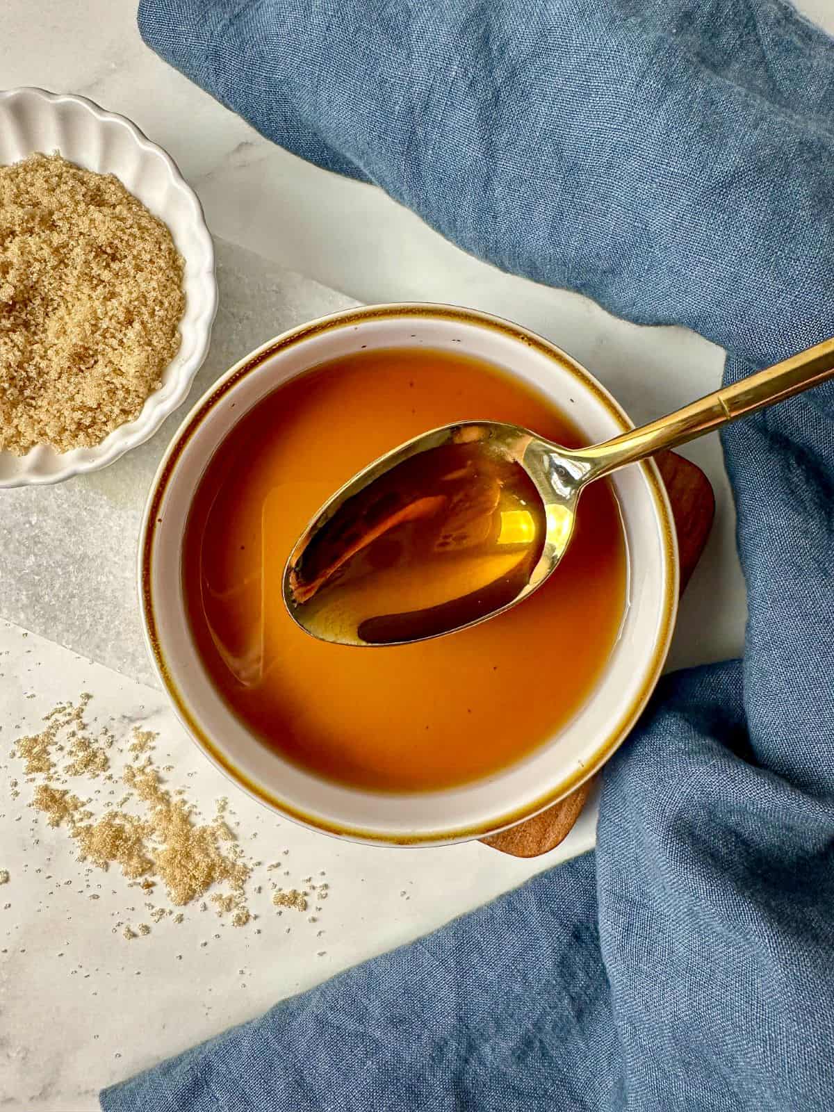 Brown sugar simple syrup in a bowl with a spoon.