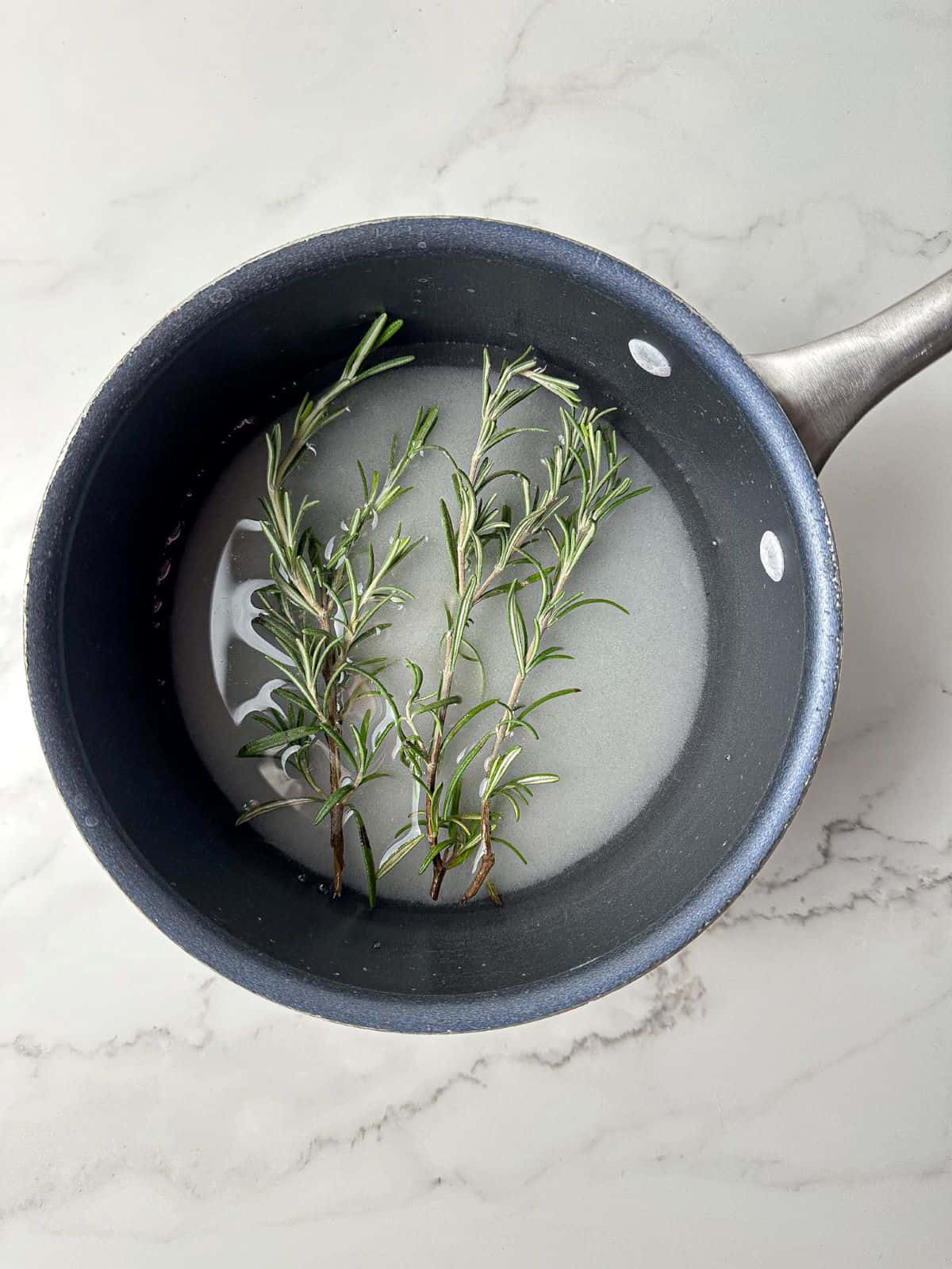 Sugar, fresh rosemary sprigs, and water in a small saucepan.