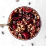 Chocolate and cherry overnight oats with a spoon.