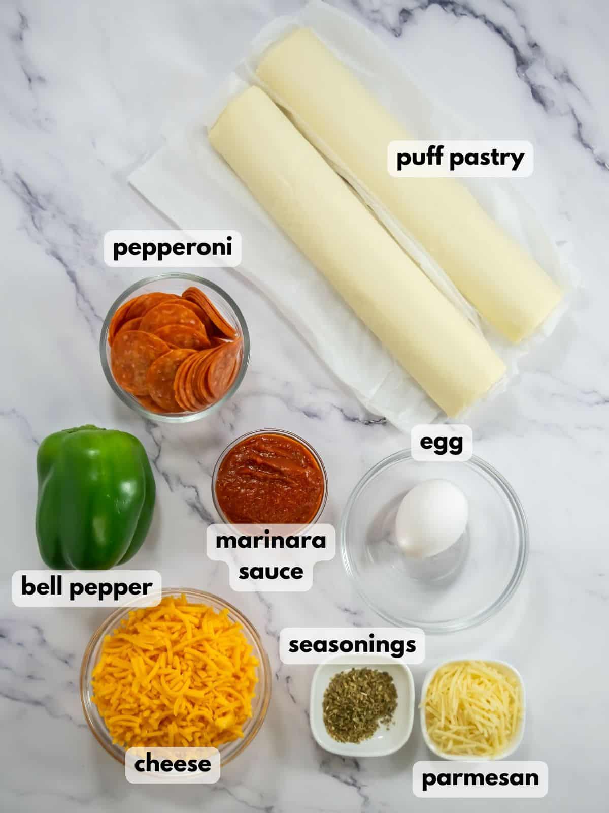 Ingredients needed to make puff pastry pizza pinwheels.