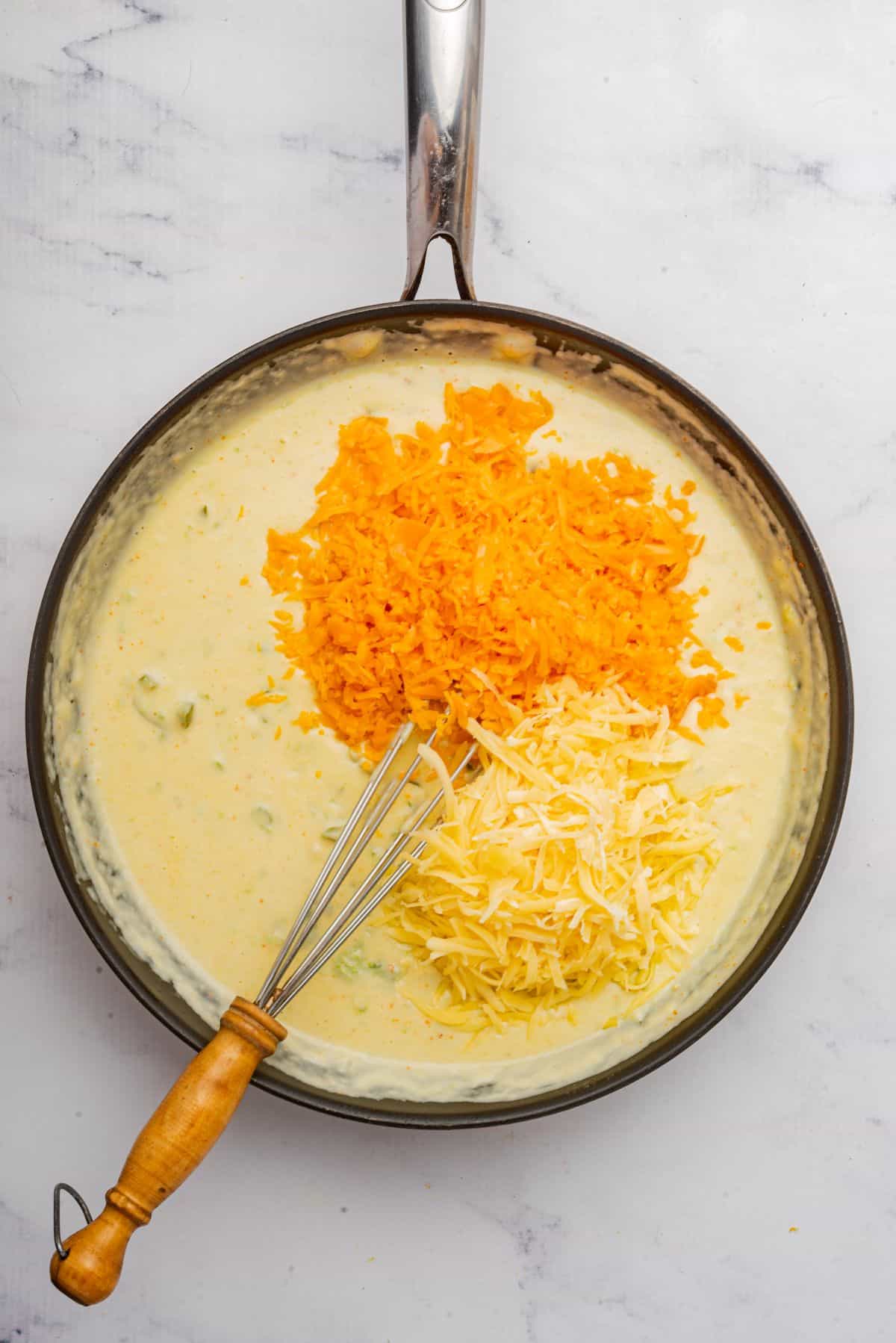 Shredded cheddar and smoked gouda added to cheese sauce.