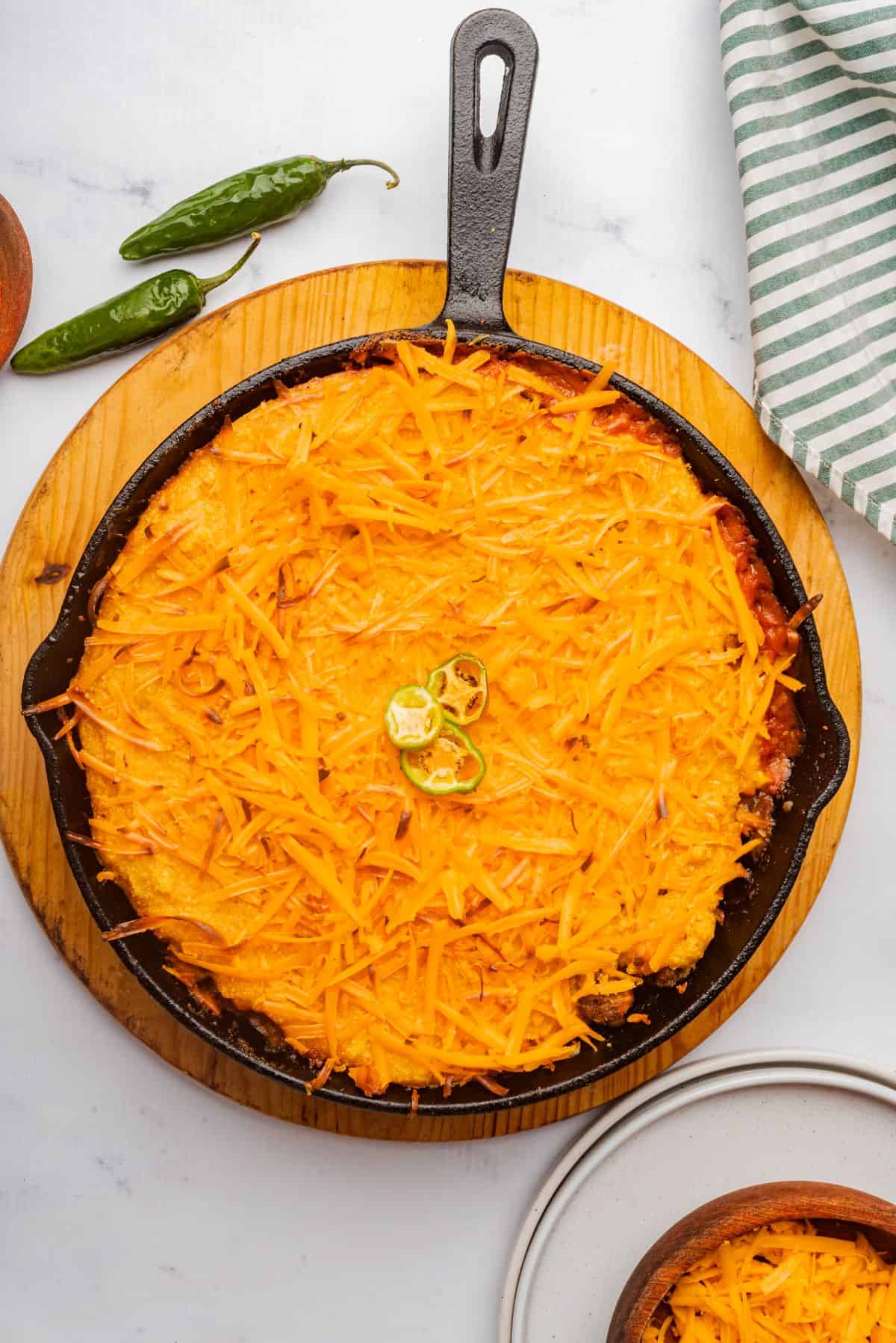 Baked tamale pie with Jiffy cornbread crust in a cast iron skillet.