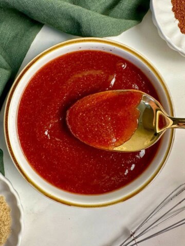 Homemade Texas BBQ sauce recipe in a bowl with a spoon.