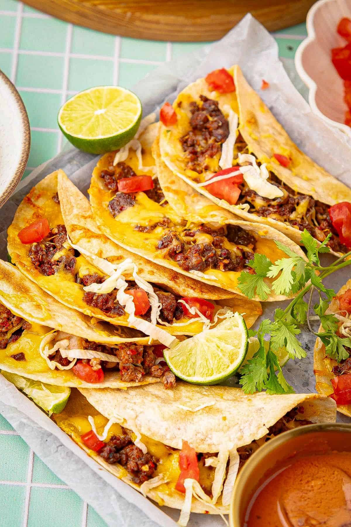 Baked tacos with ground beef, cheese, lettuce, and tomatoes.