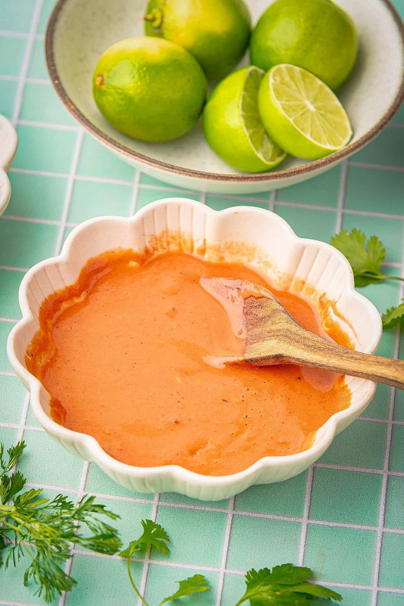 Spicy taco sauce in a bowl with a wooden spoon.