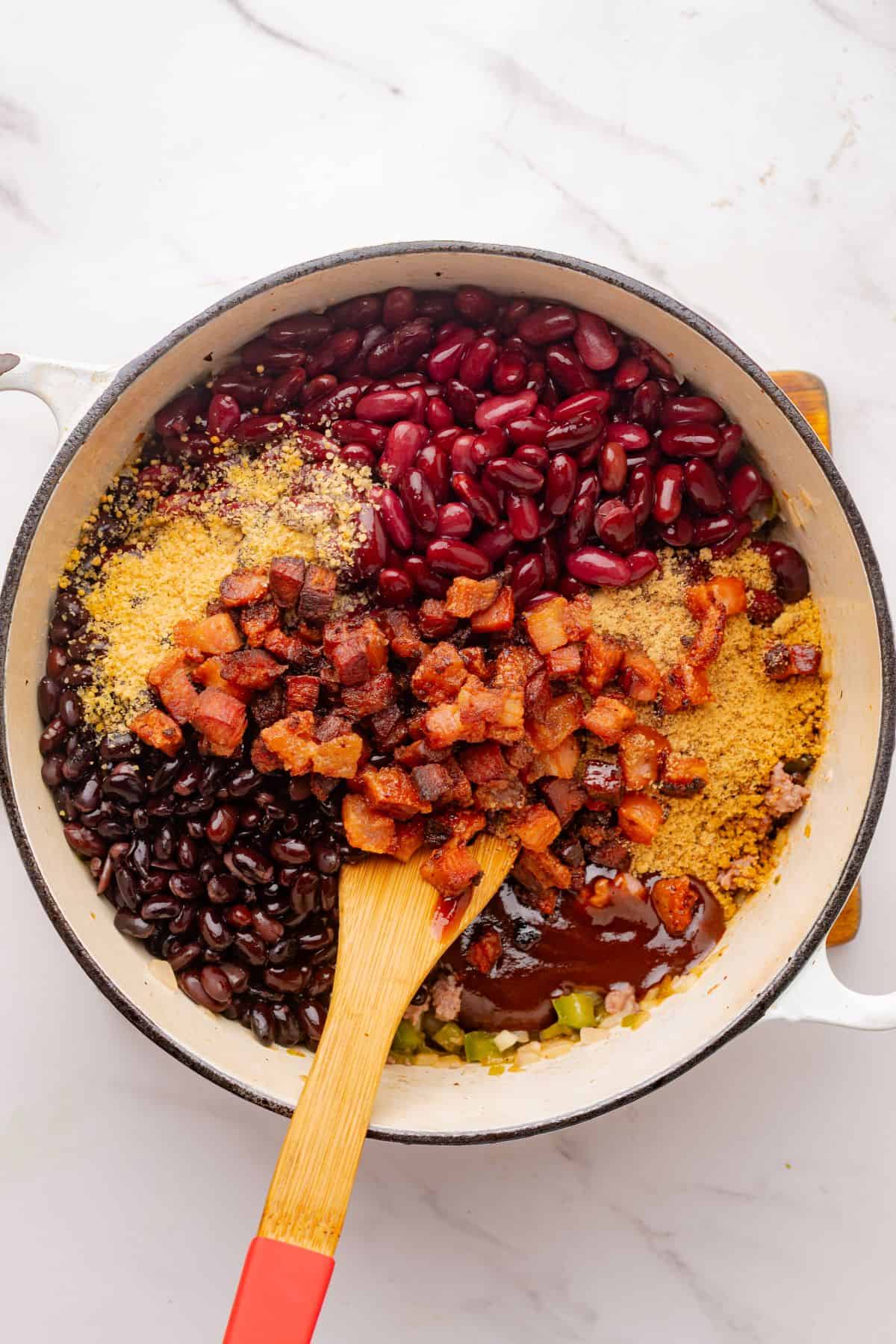 Beans added to ground beef and veggies in Dutch oven.