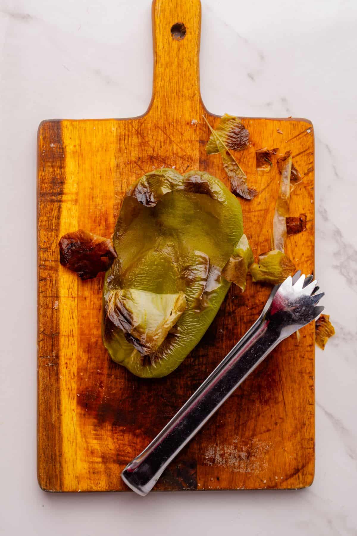 Removing the skin from a roasted poblano pepper.