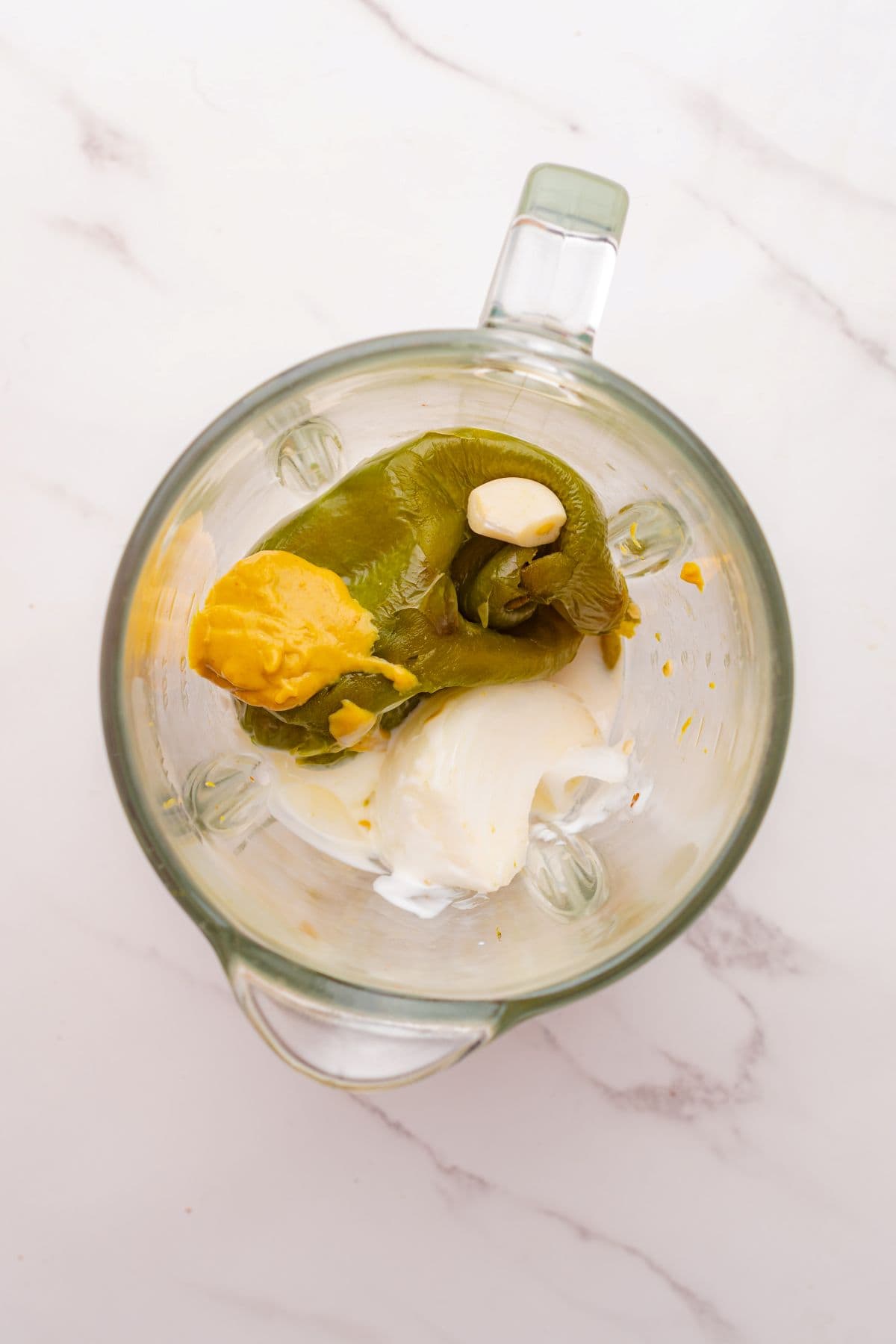 Poblano cream sauce ingredients in a blender.