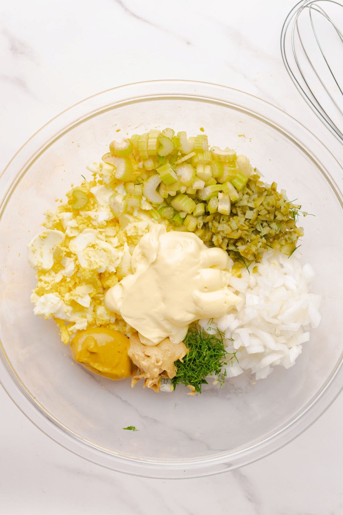 Mustard potato salad dressing ingredients in a mixing bowl.