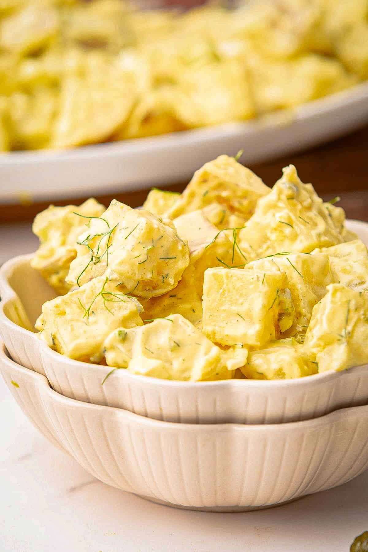 Southern potato salad with mustard and mayo dressing in a bowl.