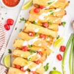 Baked chicken taquitos on a serving platter.