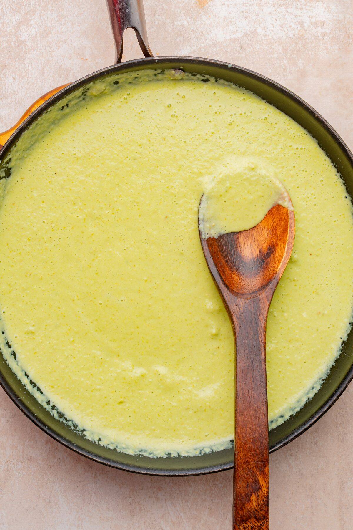 Poblano sauce in a skillet with a wooden spoon.