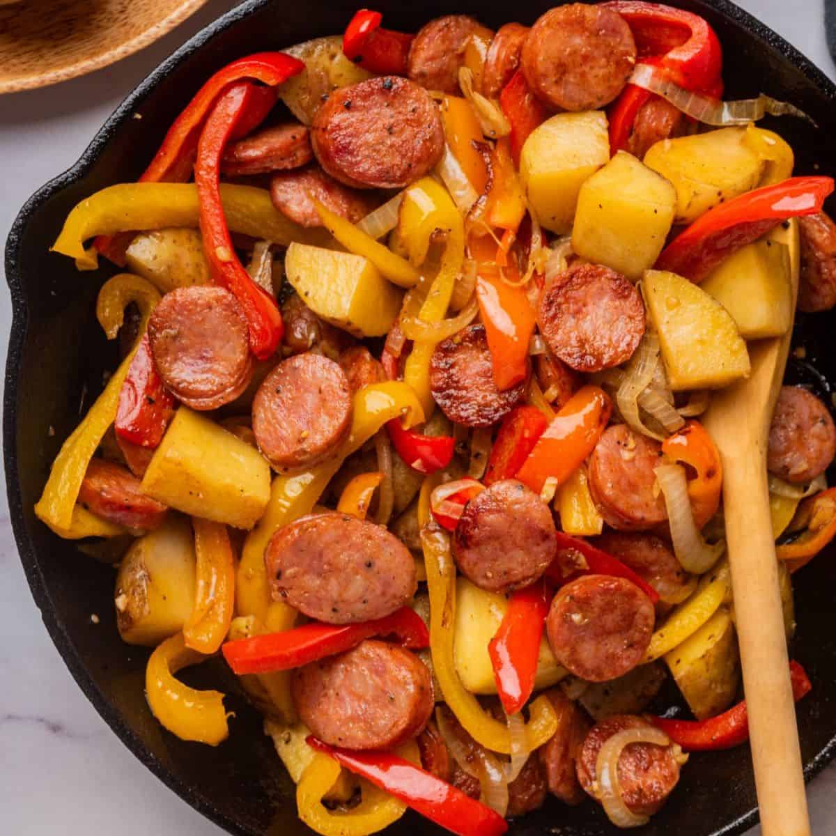 Pork sausage skillet dinner in a cast iron pan, viewed from overhead.