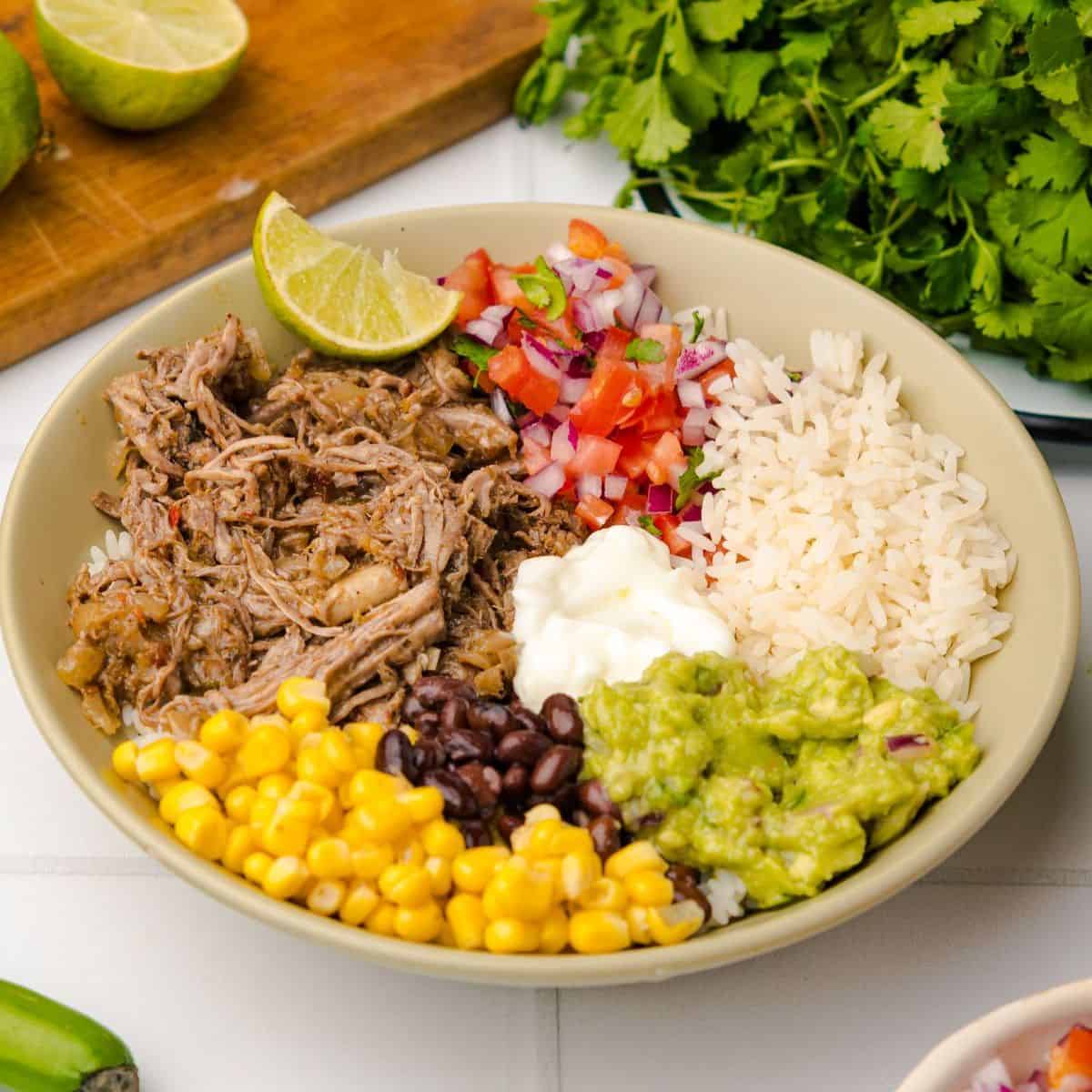 Tex-Mex dinner bowl with shredded beef, corn niblets, black beans, and guacamole.