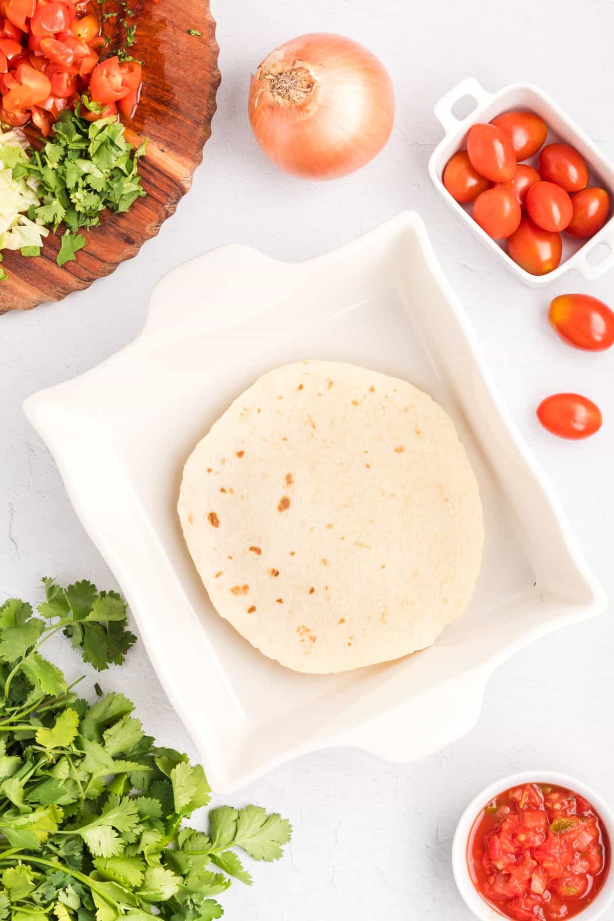 Baking dish with a flour tortilla at the bottom.