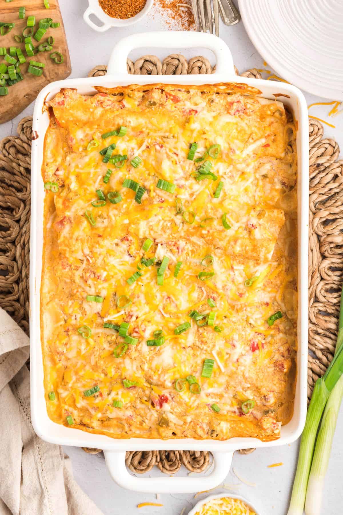 Cream cheese chicken enchiladas in a baking dish.