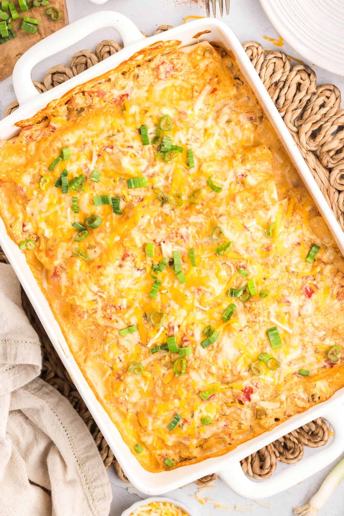 Cream cheese chicken enchiladas in a baking dish.