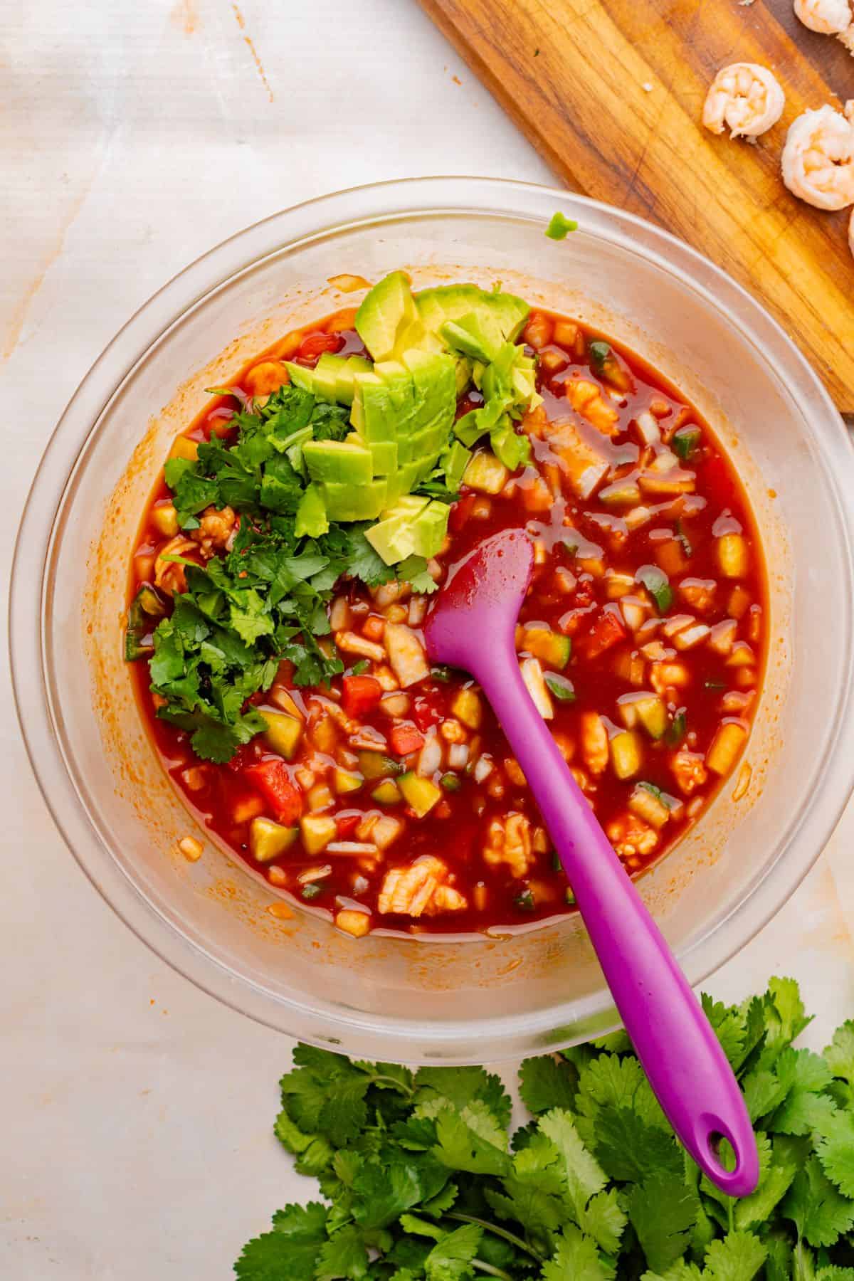 Avocado and cilantro added to the Mexican shrimp cocktail mixture.