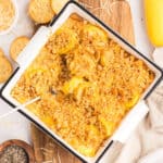 Southern squash casserole in a baking dish with a topping of Ritz crackers.