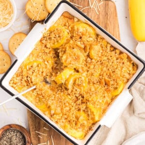 Southern squash casserole in a baking dish with a topping of Ritz crackers.